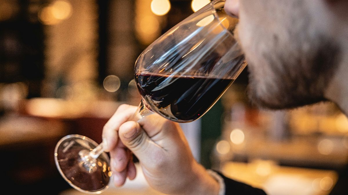 Mann trinkt Rotwein als Symbol für Alkohol und seinen möglichen Einfluss auf Spermienqualität und männliche Fruchtbarkeit