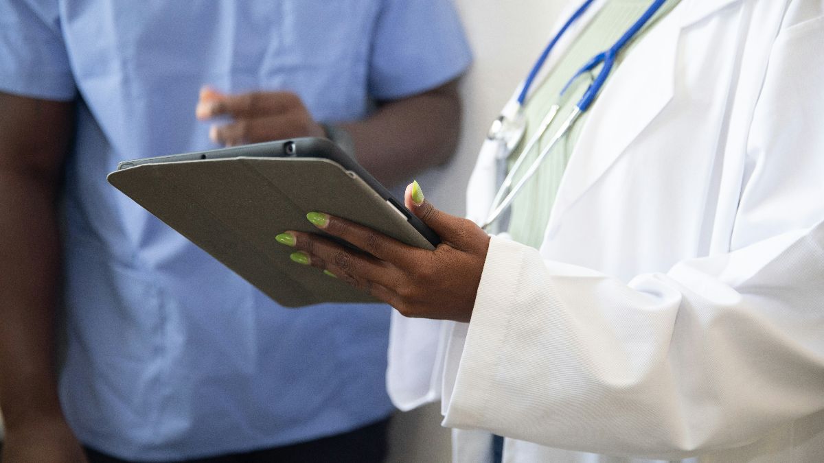 Ärztin mit Tablet als Symbol für Kinderwunschbehandlung, Krankenkasse und Kostenübernahme von IVF oder ICSI