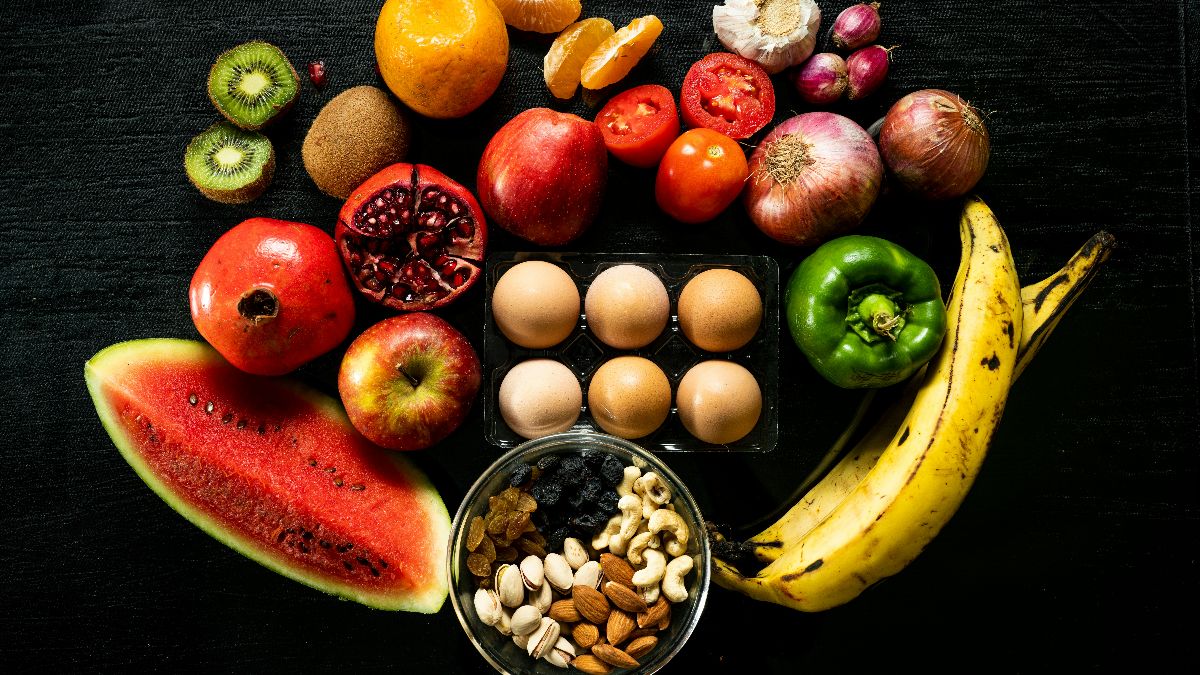 Frisches Obst, Gemüse, Eier und Nüsse als Symbol für PCOS-Ernährung, Blutzuckerbalance und Fruchtbarkeit